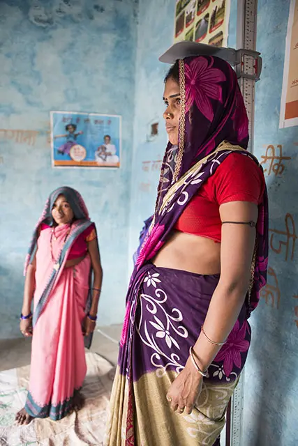 A pregnant woman is weighed during a prenatal visit. Photo by: Sujata Khanna