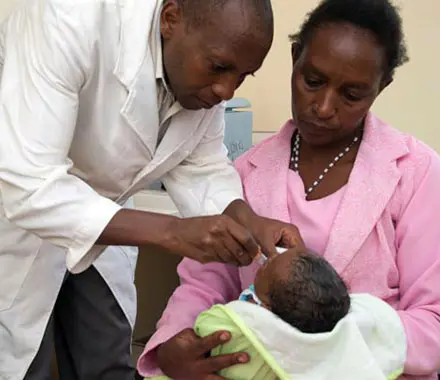 A doctor administers the Rotovirus vaccine to an infant.