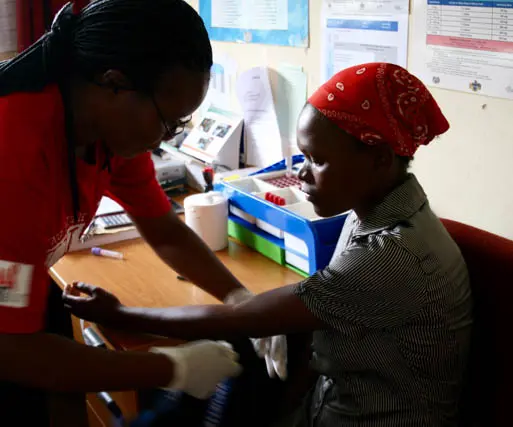 Health worker testing a woman in Swaziland for HIV.
