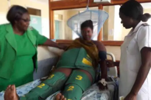 A woman has a NASG applied as she waits for emergency transport to the hospital.