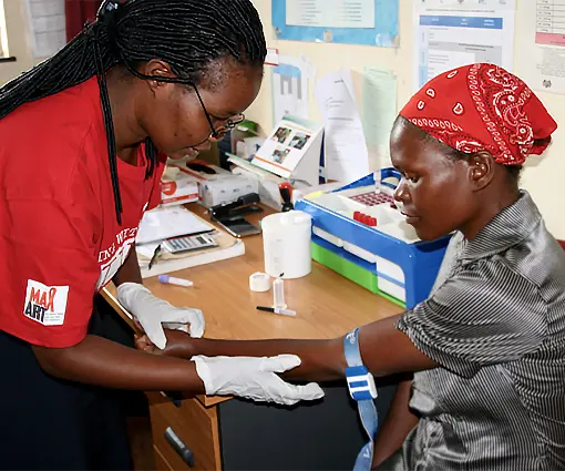 Medium shot of a female nurse checking the BP of a woman living with HIV in Eswatini