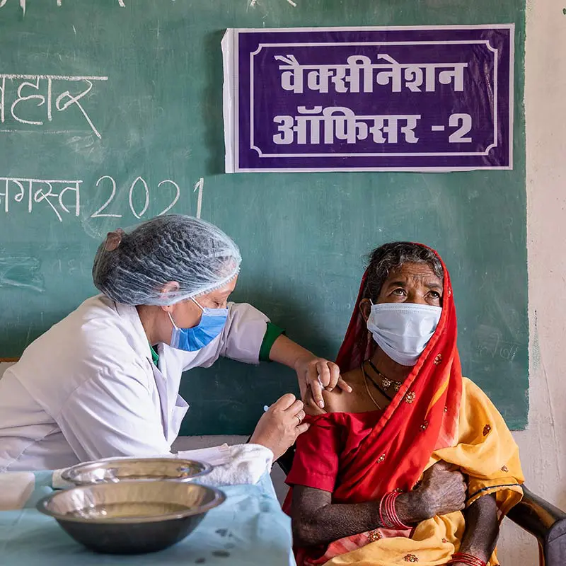 A healthcare worker administers the COVID-19 vaccine to a patient in Madhya Pradesh, India