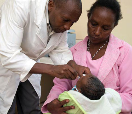 A doctor administers the Rotovirus vaccine to an infant.