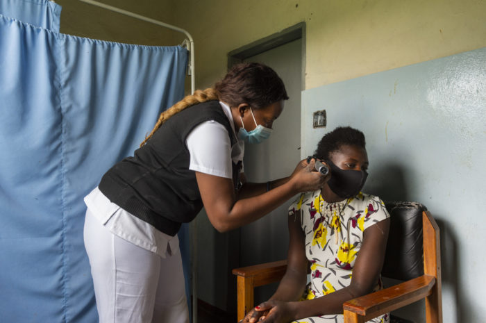 Nurse Carol Sinkende conducts a follow-up hearing consultation with patient Beatrice Mutale at the Lukomba Rural Health Centre in Kapiri Mposhii District, Zambia on 8 February 2021. Photo by Kota Kita