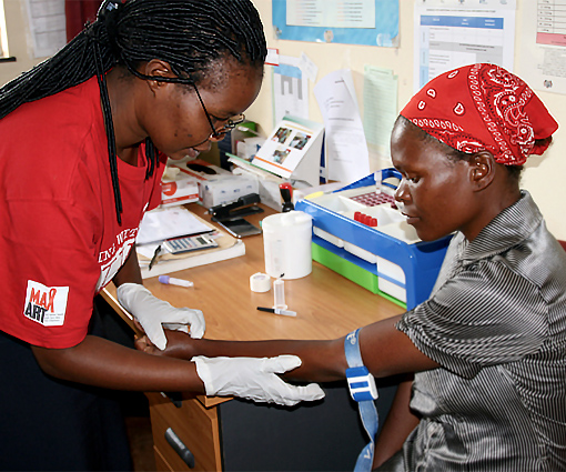 Medium shot of a female nurse checking the BP of a woman living with HIV in Eswatini