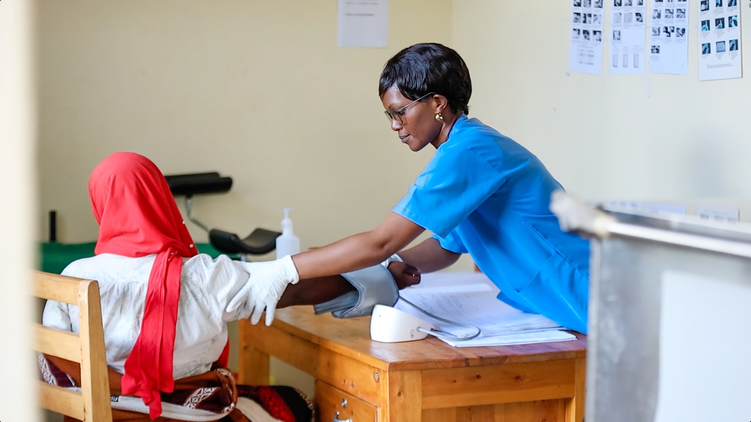 A nurse tests a female patient for hepatitis C in Rwanda