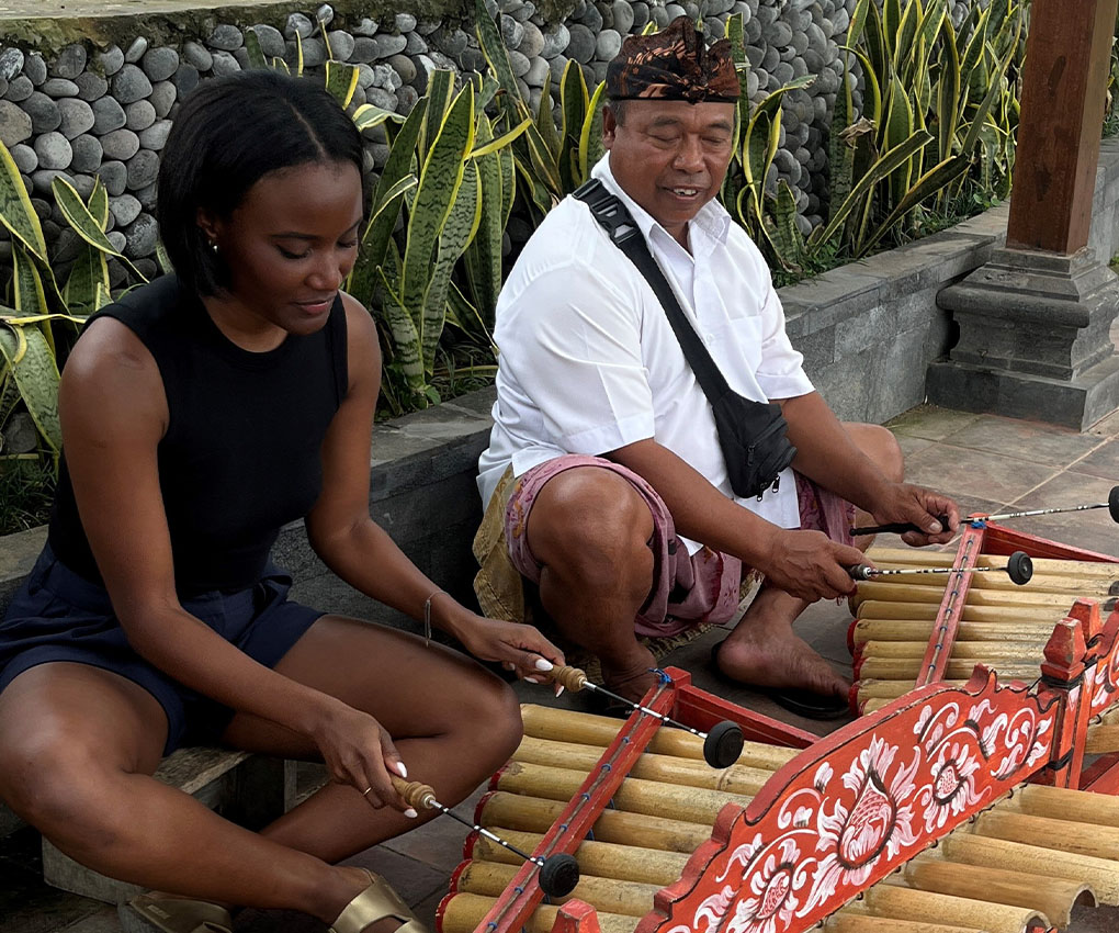 Photo of Briony Pasipanodya sitting and playing music with a man