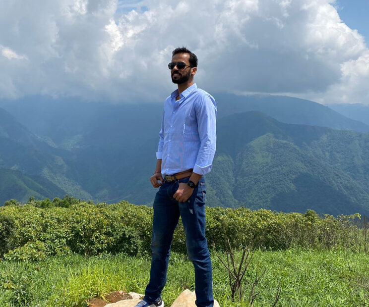 Photo of Ritubhan Gautam standing in a mountainous landscape