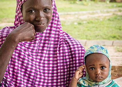 A mother and daughter smile at the camera. Photo by: Melinda Stanley